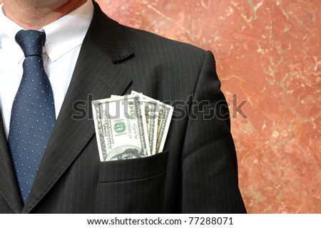 Money in the pocket of business suit