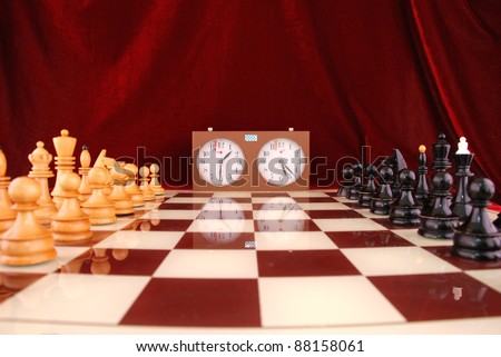 chess board and chess clock on a red background