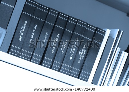 Law books on a bookshelf in a library, blue tone