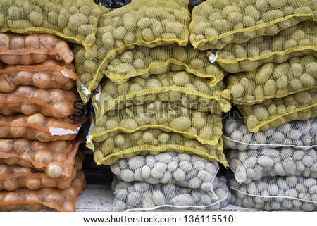 Potatoes and onions in grocery bags, business and finance