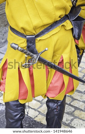 Medieval soldier with sword and uniform historical recreation, culture