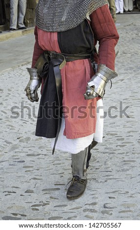 Medieval warrior in uniform symbolic and metal armor, celebration and event