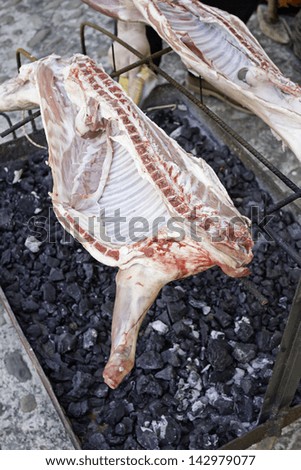 Barbecue with roasting lamb, food and butcher