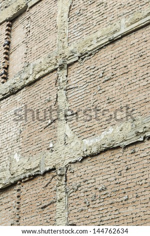 Bricked wall of cement and bricks in street, construction and architecture