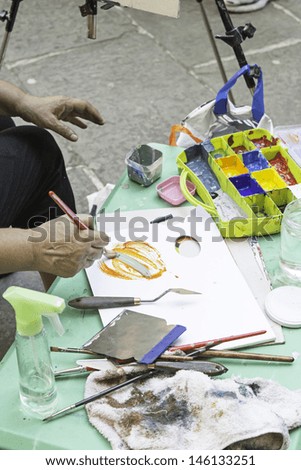 Artist painting a picture Oil in the street, art and creation