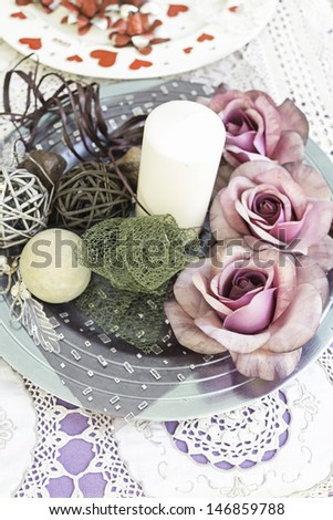 Centerpiece with pink flowers and candle, decoration restaurant