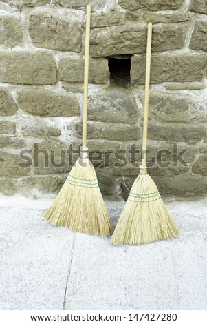 Old straw broom in urban street cleaners