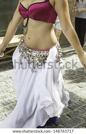 Belly dancing in celebration girl in street, East