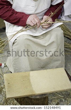 Female braiding wheat working on market, accion and craft