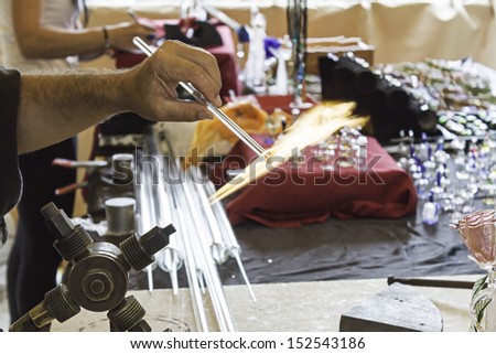 Glass blower working on crafts market, manufacture and workshop