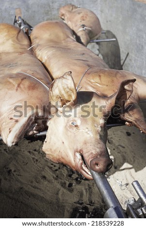 Pig roasting on the grill in restaurant, food