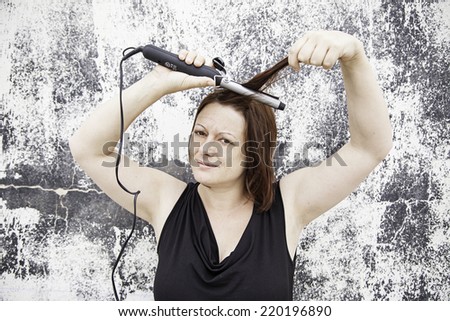 Girl combing hair irons, fashion and beauty