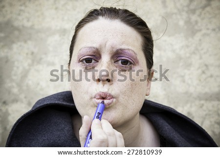 Girl painting her lips with makeup