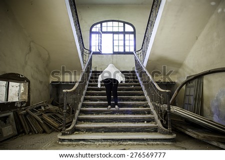 Ghostly woman in abandoned house staircase