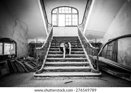 Ghostly woman in abandoned house staircase