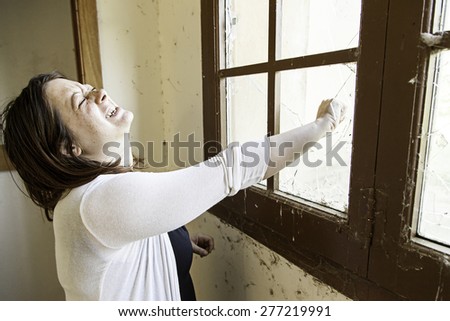 Girl hand window breaking, pain and fear