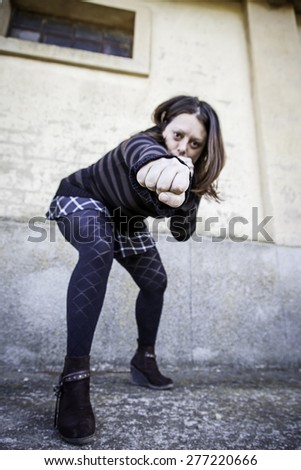 Woman giving fist aggressively urban street