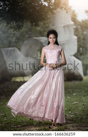 Asian Girl in wedding dress in the forest