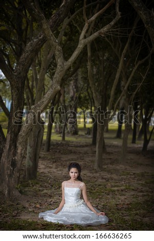 Asian Girl in wedding dress in the forest