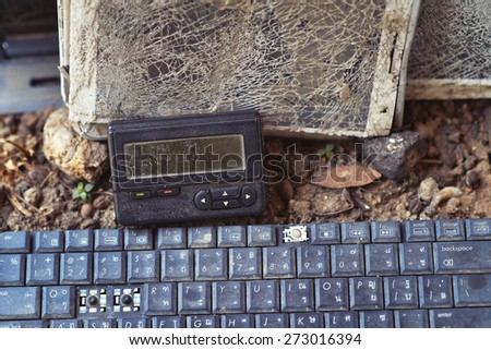 An old broken pager and keyboard