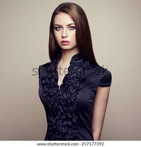 Portrait of young beautiful girl with brown hair. Fashion photo Hairstyle. Make up. Vogue Style.