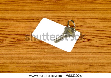business card and keys on wood background