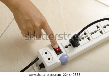 asia woman hand turn on switch multiple  socket plug electric