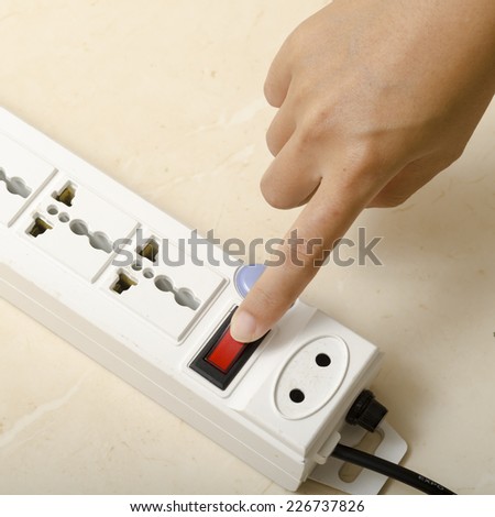 asia woman hand turn on switch multiple  socket plug electric