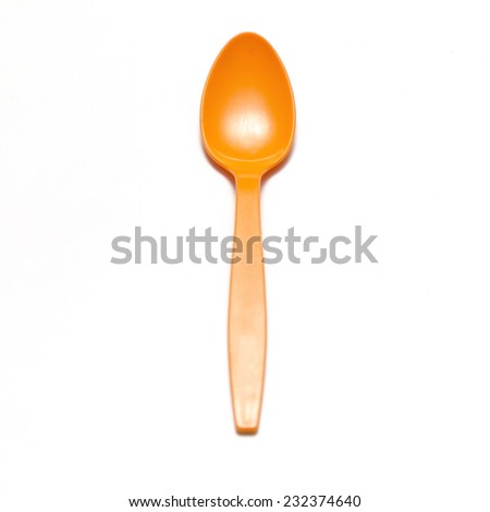 orange plastic spoon on a white background