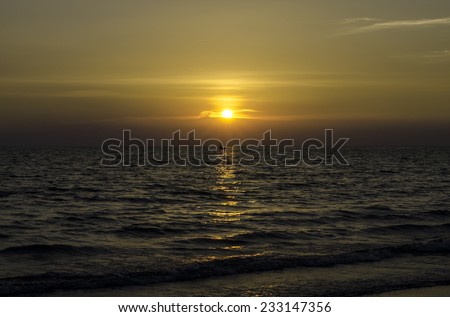Yellow Sun Set in The Middle of The Ocean and very very small boat