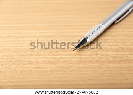 pen on wood background