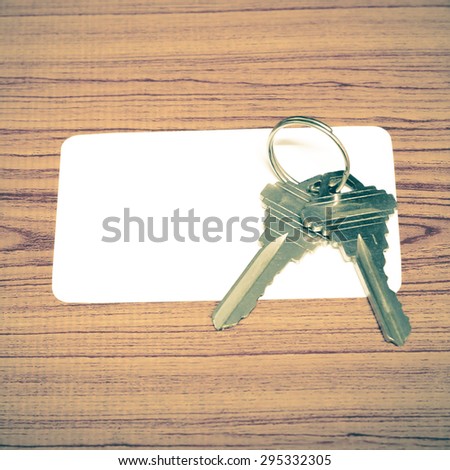 business card and keys on wood background vintage style