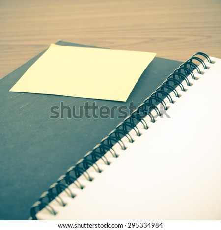 open notebook with post it on wood background vintage style