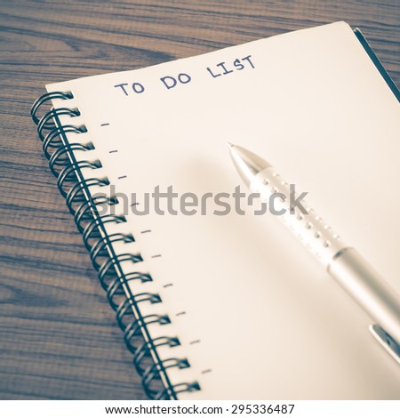 notebook and pen with word to do list on wood background vintage style