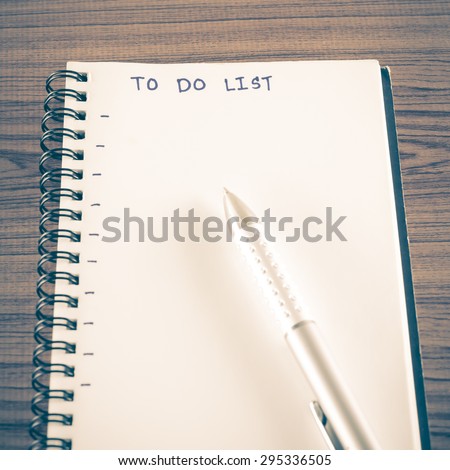 notebook and pen with word to do list on wood background vintage style
