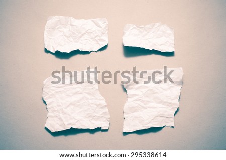 piece of white crumpled paper on brown background vintage style