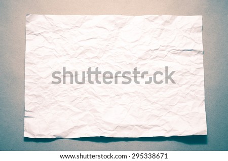 a4 size white crumpled paper on brown color background vintage style