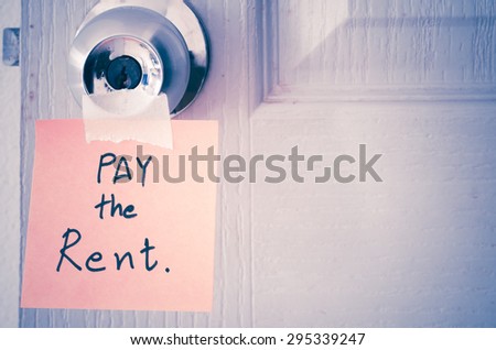 sticky note write a message pay the rent on the latch door vintage style