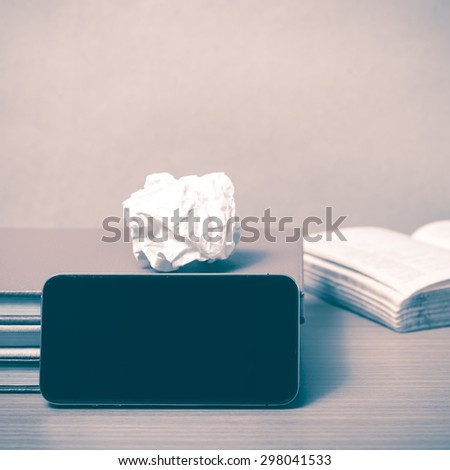 stack of book with smart phone on wood background vintage style