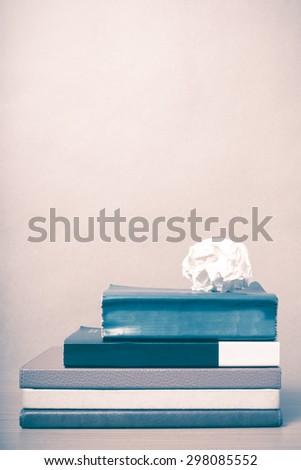 book and crumpled paper on wood background vintage style