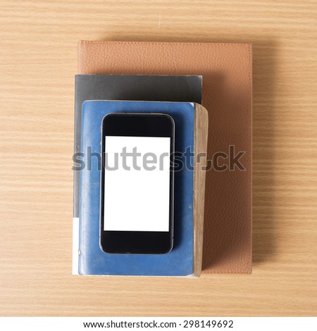 stack of book and smart phone on wood background