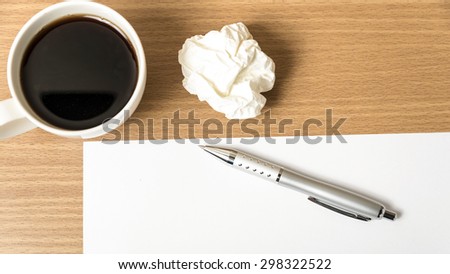 paper and crumpled with pen and coffee cup on wood background