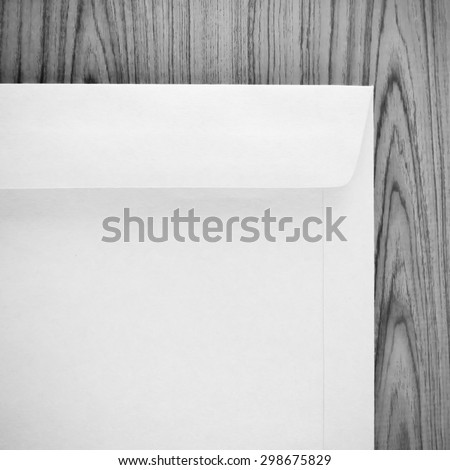 brown envelope on wood table background black and white color tone style
