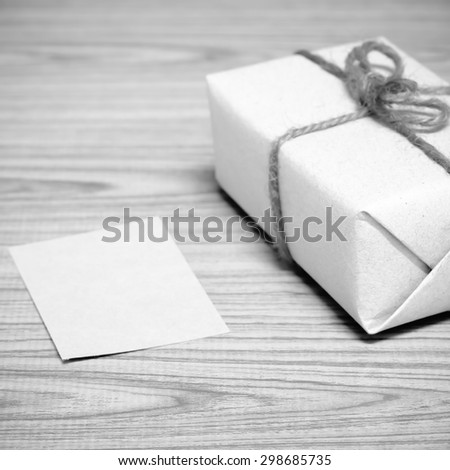 gift box and card on wood background black and white color tone style