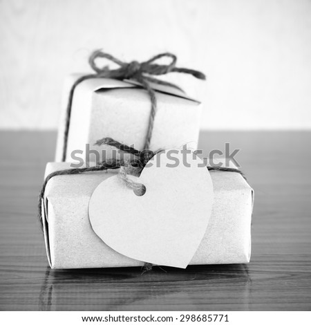 gift box with heart tag card on wood background black and white color tone style