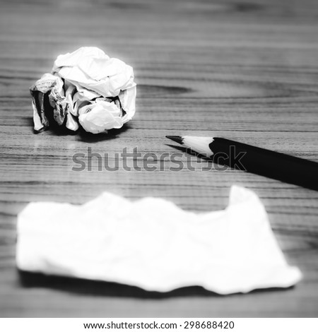 paper scrap and crumpled with pencil on wood background black and white color tone style