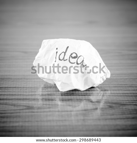 writing idea word on crumpled on wood background black and white color tone style
