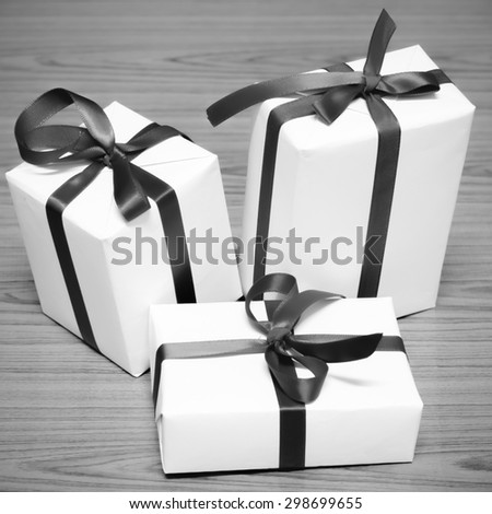 gift box and ribbin on wood background black and white color tone style