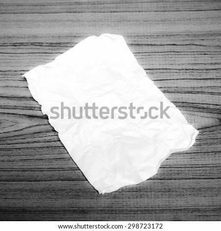 paper scrap on wood background black and white color tone style