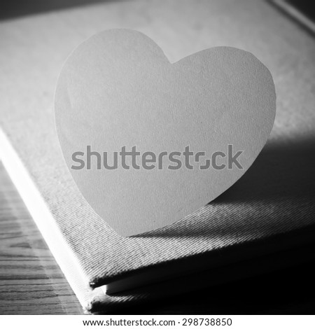diary of love with notebook and heart on wood background black and white color tone style